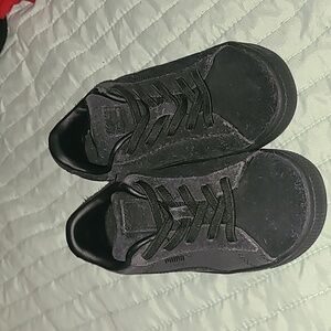 Black on black slip on Puma sneakers, elastic laces